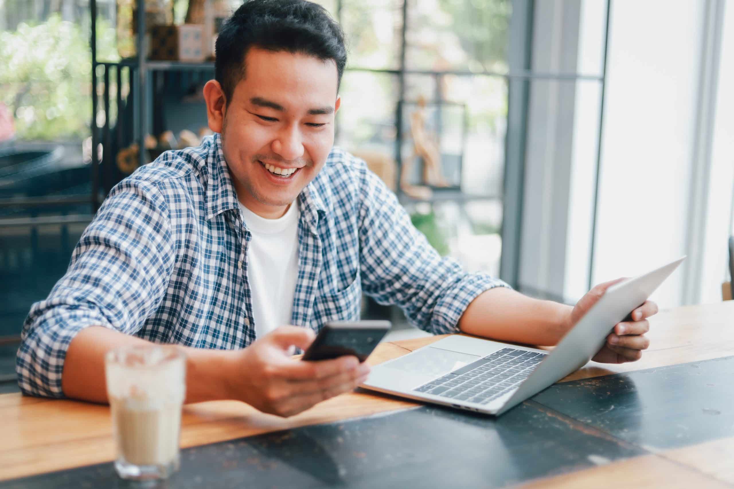 young man smiling while studying