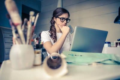 young woman concentrating on laptop screen